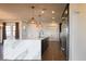 Spacious kitchen island with marble countertop, stylish pendant lights, and stainless steel appliances at 6110 Pebble Glen Ct, Las Vegas, NV 89149