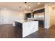 Bright kitchen features a marble island, stainless steel refrigerator, and open floor plan at 6110 Pebble Glen Ct, Las Vegas, NV 89149