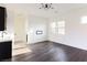 Open-concept living room with modern lighting, hardwood floors, and multiple windows for natural light at 6110 Pebble Glen Ct, Las Vegas, NV 89149