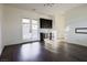 Bright living area with hardwood floors, french doors, and modern bar area, creating a welcoming space at 6110 Pebble Glen Ct, Las Vegas, NV 89149