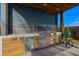 Outdoor kitchen with a built-in grill, refrigerator, and stainless steel cabinets, perfect for entertaining at 6110 Pebble Glen Ct, Las Vegas, NV 89149
