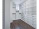 Large walk-in closet featuring custom white shelving, drawers, and compartments for ample storage at 6110 Pebble Glen Ct, Las Vegas, NV 89149