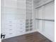 Spacious walk-in closet with custom white shelving, drawers, and dark hardware for optimal organization at 6110 Pebble Glen Ct, Las Vegas, NV 89149