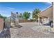 Expansive backyard features gravel landscaping, greenhouse, and covered patio perfect for outdoor living and gardening at 6125 Desert Haven Rd, Las Vegas, NV 89130