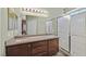 Modern bathroom featuring double sinks, large mirror, and a walk-in shower at 6125 Desert Haven Rd, Las Vegas, NV 89130