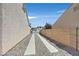Home features a gated driveway with concrete runners, offering privacy and security at 6125 Desert Haven Rd, Las Vegas, NV 89130