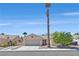 Inviting single-story home with a desert landscape, tiled roof, two-car garage and gated driveway at 6125 Desert Haven Rd, Las Vegas, NV 89130