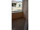 Cozy balcony area with railing, exterior door, and views of the surrounding neighborhood at 6316 Beige Bluff St # 201, North Las Vegas, NV 89081