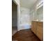 Bathroom with white tiled tub, and wood-look floors at 6316 Beige Bluff St # 201, North Las Vegas, NV 89081