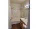 Bright bathroom featuring a tub with tiled surround and a wood vanity with laminate countertop at 6316 Beige Bluff St # 201, North Las Vegas, NV 89081