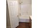 Bathroom with door to tub and shower area, vanity and wood-look floor at 6316 Beige Bluff St # 201, North Las Vegas, NV 89081