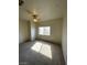 Bright bedroom with neutral carpet, a ceiling fan, and view from window at 6316 Beige Bluff St # 201, North Las Vegas, NV 89081