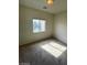 An empty bedroom featuring a window offering natural light and carpeted floors at 6316 Beige Bluff St # 201, North Las Vegas, NV 89081