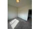 An empty carpeted bedroom featuring a closet with a laundry room just off to the side at 6316 Beige Bluff St # 201, North Las Vegas, NV 89081