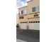 Exterior view showcasing unit numbers and garage doors enhancing curb appeal at 6316 Beige Bluff St # 201, North Las Vegas, NV 89081