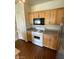 Eat-in kitchen features modern appliances, wooden cabinetry, and laminate flooring at 6316 Beige Bluff St # 201, North Las Vegas, NV 89081