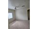 Spacious living room with neutral carpet, bright window, and ceiling fan at 6316 Beige Bluff St # 201, North Las Vegas, NV 89081