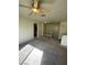 Living room with carpeted floors, fan and stair access to the second floor at 6316 Beige Bluff St # 201, North Las Vegas, NV 89081