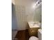 Cozy powder room features a wood vanity with laminate countertop and decorative mirror at 6316 Beige Bluff St # 201, North Las Vegas, NV 89081