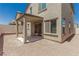 View of the home's backyard with a covered patio, sliding doors, and a low-maintenance landscape at 6443 Burlap Ct, Las Vegas, NV 89122