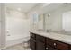 Modern bathroom with white tile and granite counters at 6443 Burlap Ct, Las Vegas, NV 89122