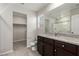 Bathroom with granite countertop vanity, open walk-in closet, and tile flooring at 6443 Burlap Ct, Las Vegas, NV 89122