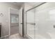 Modern bathroom featuring a glass-enclosed shower, neutral walls, and access to bedroom at 6443 Burlap Ct, Las Vegas, NV 89122