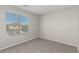 Neutral bedroom with carpet, a window, and light walls at 6443 Burlap Ct, Las Vegas, NV 89122