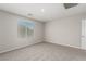 Bright, carpeted bedroom features a window for natural light and neutral walls at 6443 Burlap Ct, Las Vegas, NV 89122