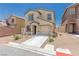 Charming two-story home featuring a tan stucco exterior, a well-manicured yard, and an attached garage at 6443 Burlap Ct, Las Vegas, NV 89122