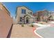 Attractive two-story home with desert landscaping, neutral stucco, complemented by adjacent homes in the neighborhood at 6443 Burlap Ct, Las Vegas, NV 89122