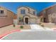 Charming two-story home featuring a tan stucco exterior, a well-manicured yard, and an attached garage at 6443 Burlap Ct, Las Vegas, NV 89122