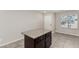 Kitchen island with granite countertop and seating at 6443 Burlap Ct, Las Vegas, NV 89122