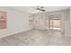Bright living room with tile flooring, large windows, and sliding glass doors leading to the backyard at 6443 Burlap Ct, Las Vegas, NV 89122