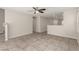 Open living room with tile flooring, natural light, and a view of the kitchen and stairway at 6443 Burlap Ct, Las Vegas, NV 89122