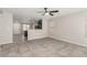 Open-concept living room with tile flooring, ceiling fan, and natural light at 6443 Burlap Ct, Las Vegas, NV 89122