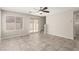 Spacious living room featuring tile floors, a ceiling fan, and stairs to the second floor at 6443 Burlap Ct, Las Vegas, NV 89122