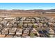 Sprawling community of modern homes with desert landscape and mountain views in the distance at 6618 Tangled Vines Ave, Las Vegas, NV 89139