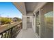 Balcony with wrought iron railing overlooks the neighborhood street at 6618 Tangled Vines Ave, Las Vegas, NV 89139