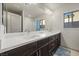 Bathroom showcasing dual sinks, a large mirror, and a shower-tub combo at 6618 Tangled Vines Ave, Las Vegas, NV 89139