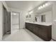 This bathroom has a double vanity, a large mirror, and plenty of lighting at 6618 Tangled Vines Ave, Las Vegas, NV 89139