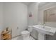 Half bath featuring modern fixtures including a toilet and a pedestal sink at 6618 Tangled Vines Ave, Las Vegas, NV 89139