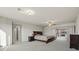 This bedroom features plush carpet, a ceiling fan, and a large bed at 6618 Tangled Vines Ave, Las Vegas, NV 89139