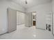 Bedroom featuring light gray walls, a corner cabinet and doors to the bathroom and hallway at 6618 Tangled Vines Ave, Las Vegas, NV 89139