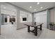Bright dining room boasts a wooden table, tile flooring, and modern decor at 6618 Tangled Vines Ave, Las Vegas, NV 89139