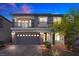 Charming two-story home boasts a stone facade, a two-car garage and a cozy second-story balcony at 6618 Tangled Vines Ave, Las Vegas, NV 89139