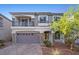 Stylish two-story home featuring stone accents, a balcony, and a well-manicured front yard at 6618 Tangled Vines Ave, Las Vegas, NV 89139