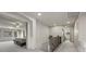 Hallway leading to a bedroom and bathroom; staircase with iron railings on the left at 6618 Tangled Vines Ave, Las Vegas, NV 89139