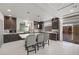 Spacious kitchen features a large island, dark cabinets, and stainless steel appliances at 6618 Tangled Vines Ave, Las Vegas, NV 89139