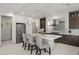Stylish kitchen featuring a central island with bar seating and dark cabinetry and stainless appliances at 6618 Tangled Vines Ave, Las Vegas, NV 89139